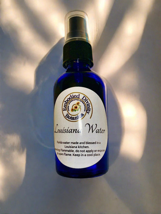 Blue bottle of Louisiana Water for spiritual cleansing and ancestral rituals