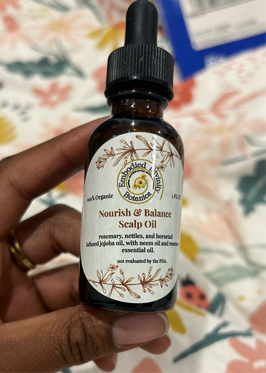 Amber ropper bottle of Nourish + Balance scalp oil with label, used for hair growth and scalp care