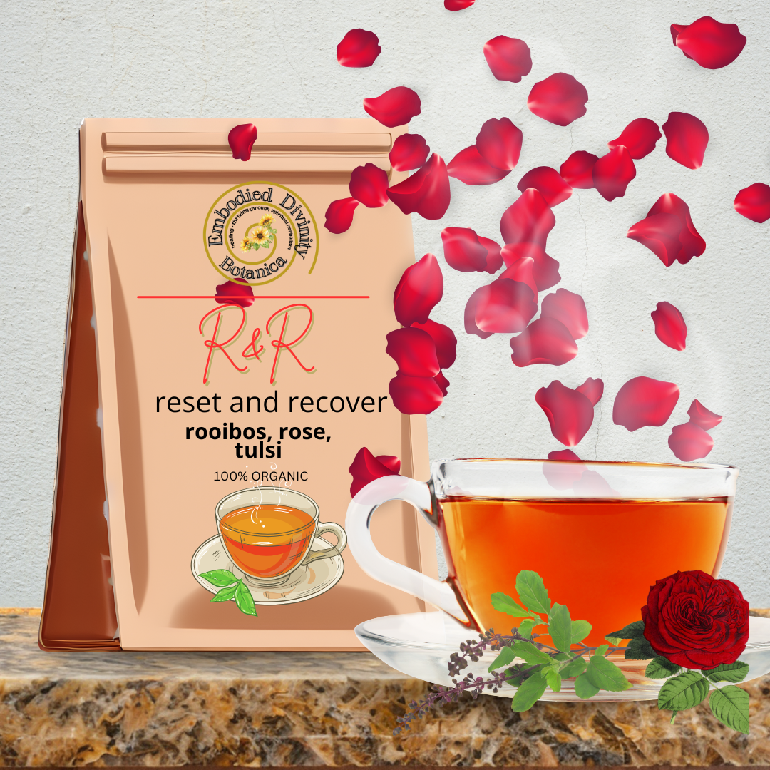 Glass teacup of Reset & Recovery Tea blend with rose petals and tulsi herbs, designed for body detox and healing